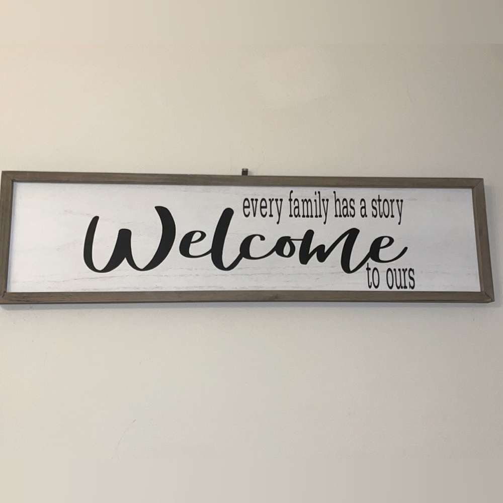 “Every Family Has a Story Welcome to Ours” sign